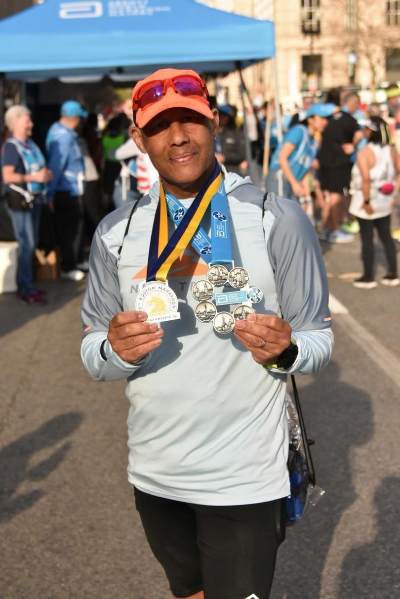 Dave the cab driver from Manchester, and some of the medals from the 95 marathons he has completed. 
