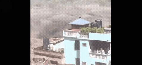 Intense video footage has emerged of powerful floodwaters barrelling around a building in Nepal as a group of fearful people huddle together on the balcony as 41 Australians are unaccounted for. 