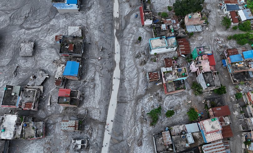 An Aerial view shows debris and mud covering an area.