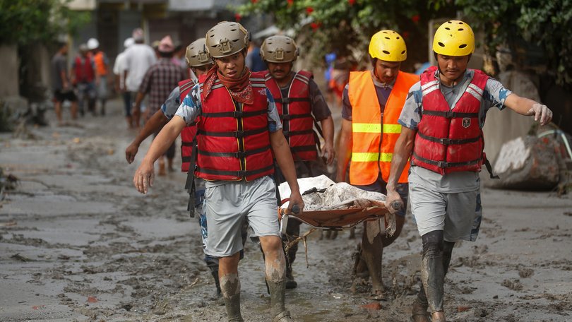 Security personnel collect the bodies of flood victims in Nuwakot, Nepal, on August 27, 2026, following an outburst of a glacial lake in Tibet.