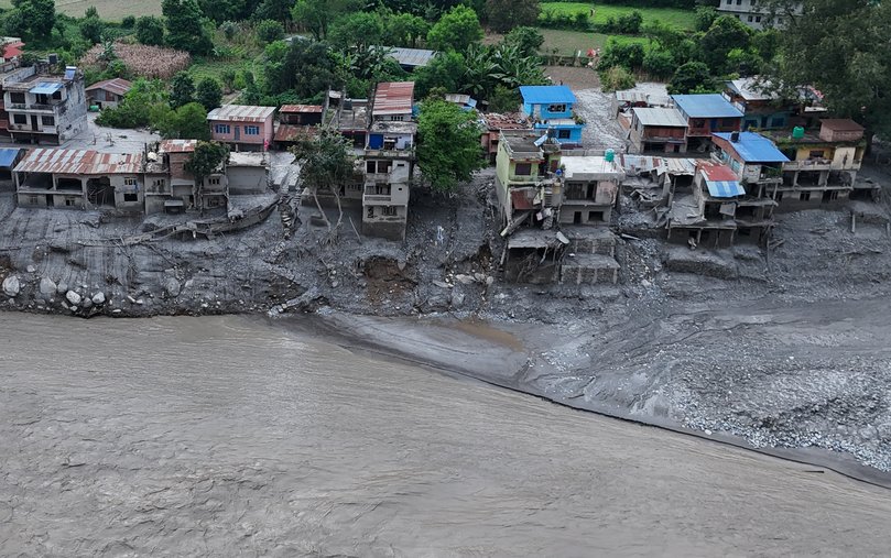 An Aerial view shows debris and mud covering settlements.