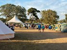 A man has been killed and six other people injured after a large sign toppled over and crushed festival-goers in England.