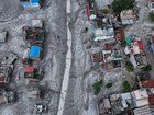 An Aerial view shows debris and mud covering an area following flash floods on August 28, 2026 in DevGhat village, Nepal. 