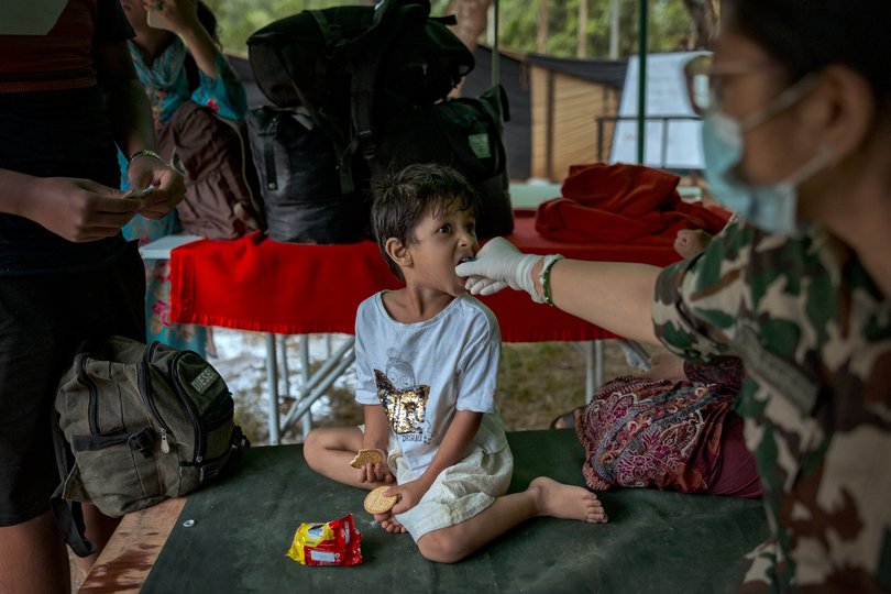 A child rescued following flash floods is given food and water at a field hospital inside a military camp on August 28, 2026 in Trishuli, Nepal.