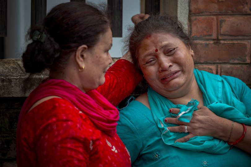 A woman cries outside Maharajgunj Medical Campus, where unidentified bodies recovered from the floods are being taken.