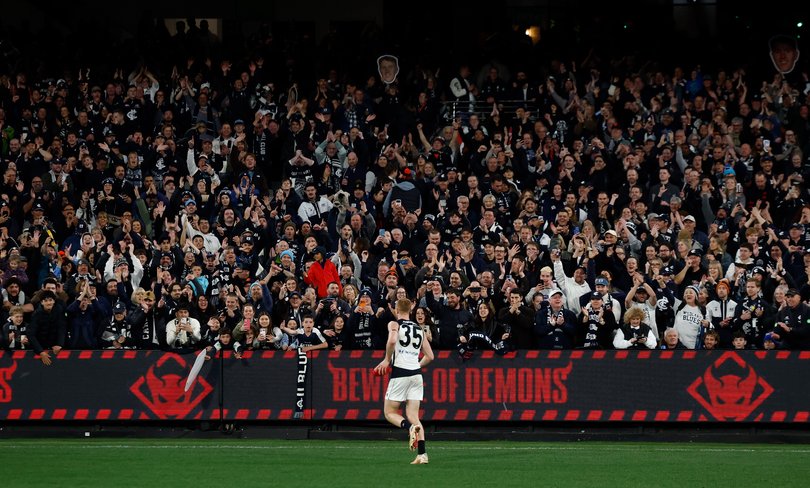 Harry Dean of the Blues celebrates with fans.
