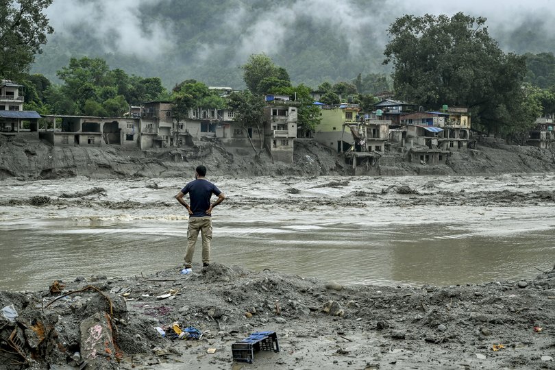 NYTSELECTS — A resident surveys houses destroyed by the flash flood next to the river in Devighat, Nepal, on Sunday, Aug. 30, 2026. Five days after an angry deluge tore through the mountain passes of Nepal, family members arriving after long journeys looked for something — anything — that could identify their loved ones amid the hundreds of mangled bodies. (Atul Loke/The New York Times)