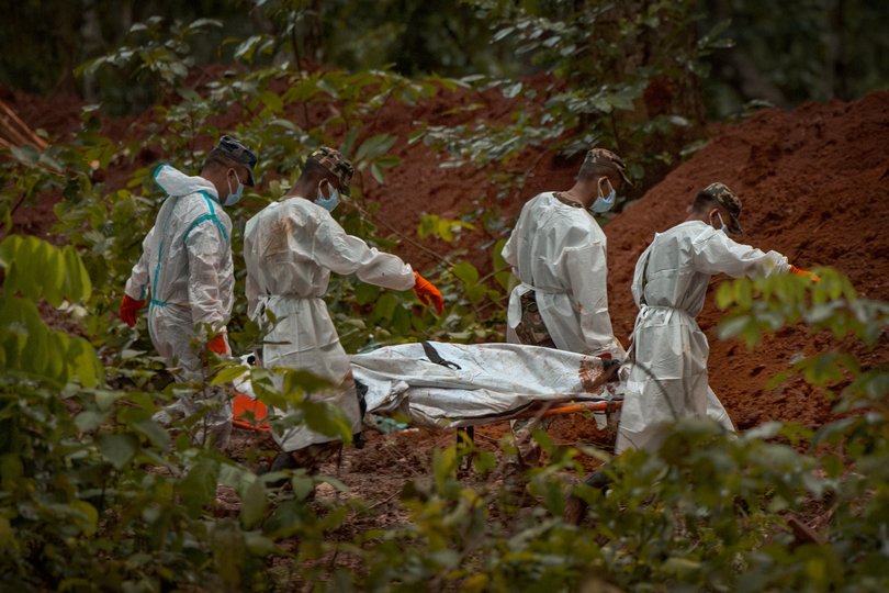 BHARATPUR, NEPAL - AUGUST 30: (EDITOR'S NOTE: Image depicts death.) Police and army personnel bury unidentified bodies recovered from the flash floods at a mass burial site in the Devghat Forest on August 30, 2026 in Bharatpur, Nepal. Authorities said the flash floods were triggered after a mass of ice, mud and rock collapsed into a Himalayan river near the Nepal-China border, leaving hundreds dead or missing and causing widespread damage in affected districts. Authorities continued the gruelling search for victims, many buried under metres of mud, as both China and Nepal issued fresh flooding alerts. (Photo by Ezra Acayan/Getty Images) *** BESTPIX ***