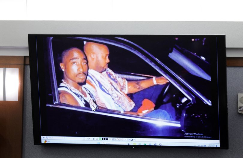 A 1996 photo of rapper Tupac Shakur (L) and Marion “Suge” Knight is  displayed during the Duane Davis murder trial.