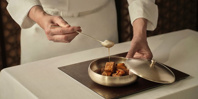 A chef plating up.