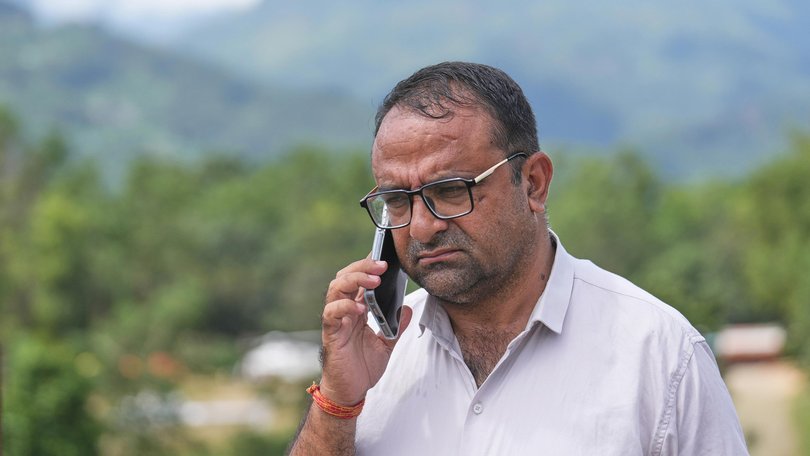 Rajendra Dawadi, a school teacher of Tribhuvan Trishuli Secondary School, talks on his mobile phone in Trishuli Valley in Nepal's Nuwakot district, Monday, Aug. 31, 2026. (AP Photo/Rajesh Kumar Singh) Rajesh Kumar Singh