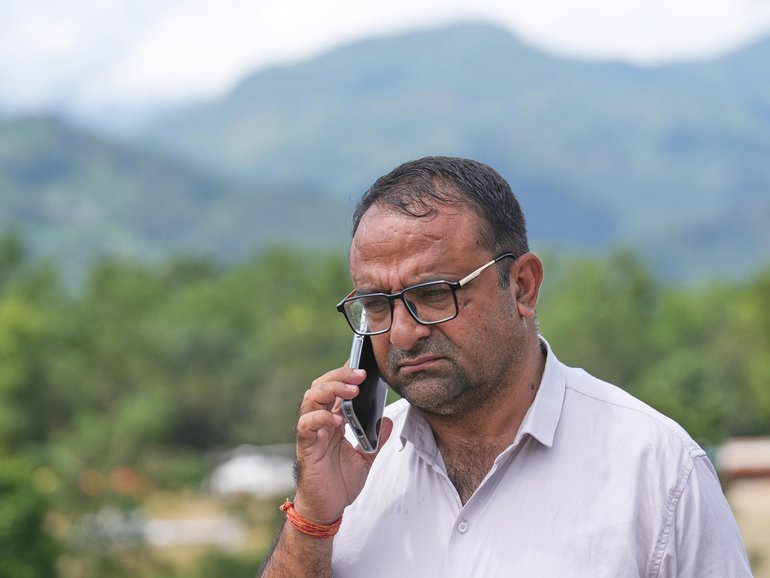 Rajendra Dawadi, a school teacher of Tribhuvan Trishuli Secondary School, talks on his mobile phone in Trishuli Valley in Nepal's Nuwakot district, Monday, Aug. 31, 2026. (AP Photo/Rajesh Kumar Singh) Rajesh Kumar Singh