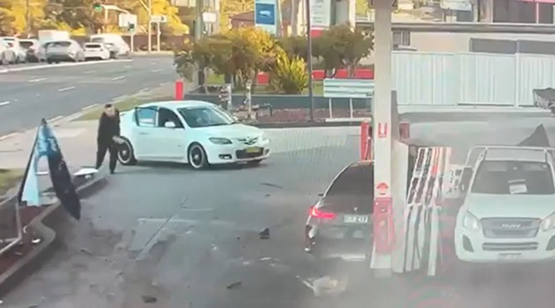 The sedan continues its trajectory into the thankfully empty bowser, which appears to partially collapse onto a vehicle on the opposite side.