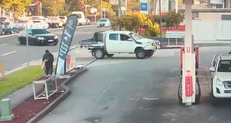 A black sedan is then pictured, swerving across several lanes before attempting to turn into the station.