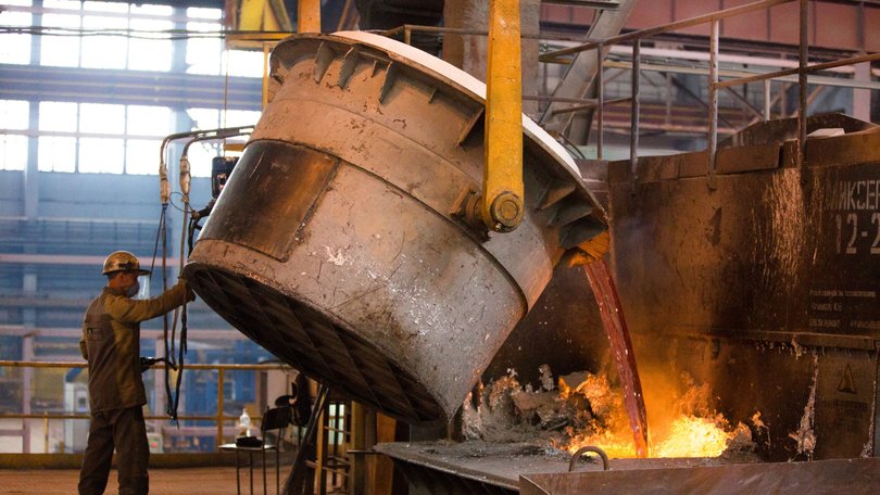 A worker pours a crucible of molten aluminum into molds in the foundry at a aluminum smelter, operated by United Co. Rusal.
