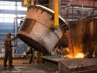 A worker pours a crucible of molten aluminum into molds in the foundry at a aluminum smelter, operated by United Co. Rusal.