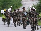 Rescuers in Nepal are contending with collapsed tunnels and floodwaters that make access difficult. 