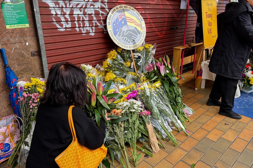 Community members lay flowers at the entrance to a local grocery store following the death of its owner, Van Viet Truong, in Melbourne, Sunday, August 9, 2026. Mr Truong died from serious injuries after he tried to help a fellow retail worker and was allegedly set upon by a group of youths.