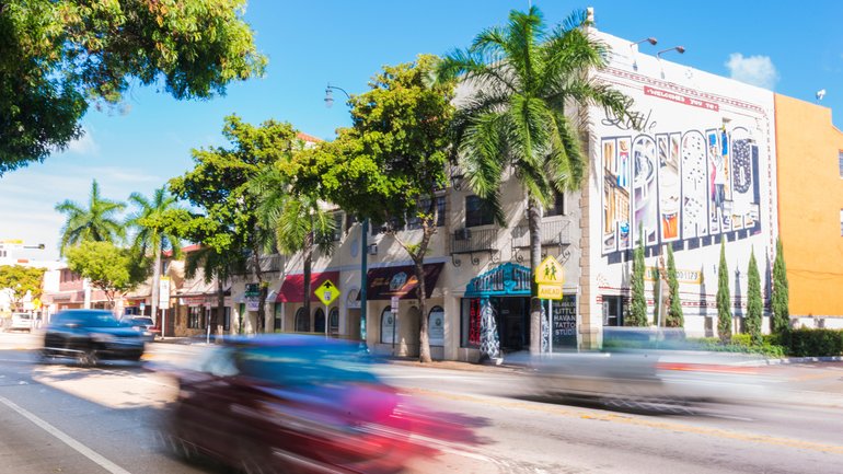 Cars zoom down the famous street Calle Ocho.