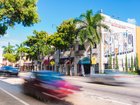Cars zoom down the famous street Calle Ocho.