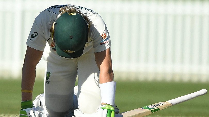 Will Pucovski of Australia A lies on the ground after being hit in the helmet by a ball from Kartik Tyagi of India A.