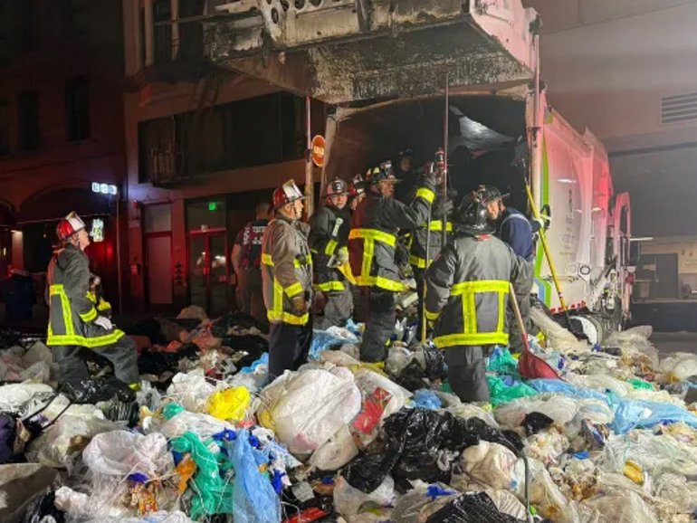 Emergency services were in a race against the clock to save a man who was trapped inside a garbage truck under a pile of waste in on Wednesday morning.