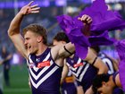  Karl Worner of the Dockers runs through the banner.