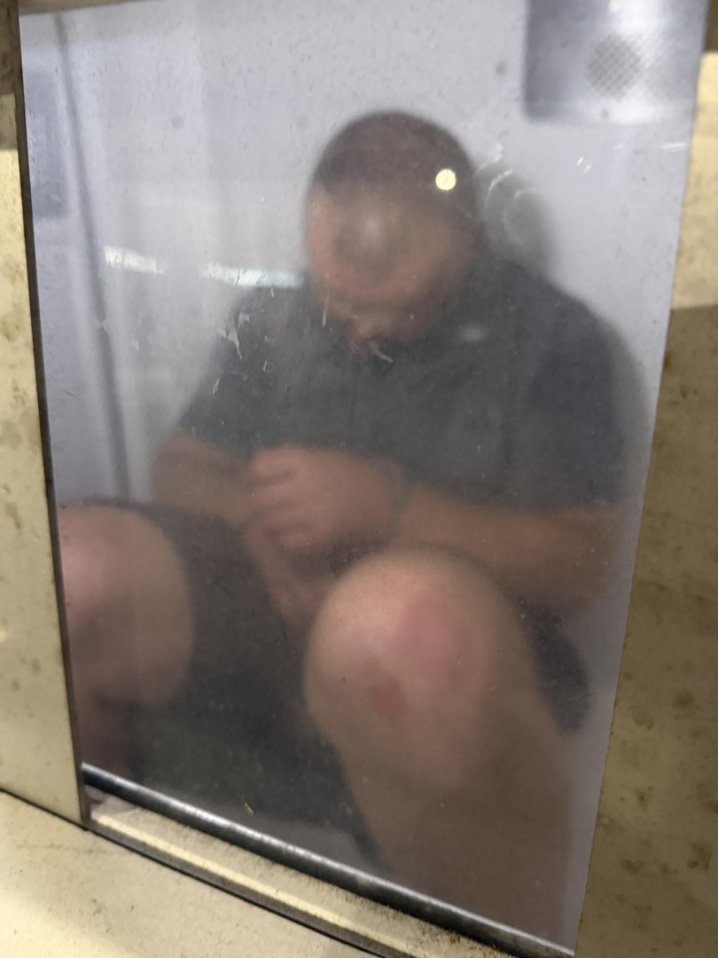 A man in custody at Sydney Airport. Picture: Elliott Stewart
