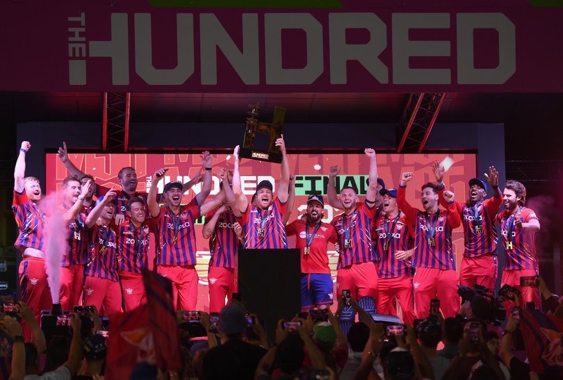 Jos Buttler of Manchester Super Giants lifts the trophy after The Hundred Final.