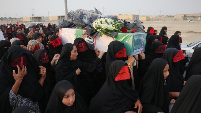 Mourners have carried caskets wrapped in the Iranian flag in the streets of port town Kuhestak. (AP PHOTO)