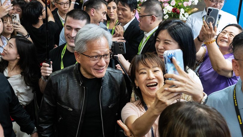 Jensen Huang takes a selfie with an attendee at Computex 2026 in Taipei.
