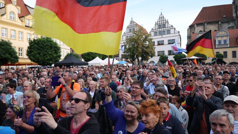 Supporters of the far-right Alternative for Germany (AfD) gather with German flags to hear AfD lead candidate Ulrich Siegmund speak at an AfD campaign rally prior to state elections in Saxony-Anhalt.