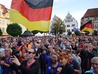 Supporters of the far-right Alternative for Germany (AfD) gather with German flags to hear AfD lead candidate Ulrich Siegmund speak at an AfD campaign rally prior to state elections in Saxony-Anhalt.