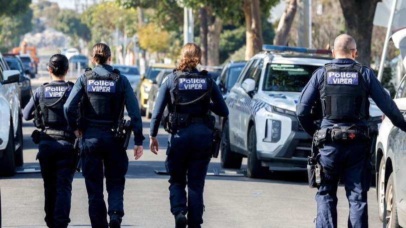 A horrific axe attack has left three people with life-threatening and critical injuries, as police continue a manhunt on Sunday.