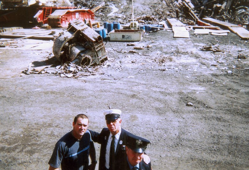 Australian Firefighter Andrew Wallace (left) with Bob Byron and Bob McGee (walking away) in New York. Andrew went to New York after the September 11 terrorist attacks to help clean up the devastation. Picture: Unknown