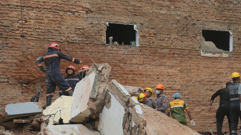 Officials say 30 to 40 people remain trapped under rubble after a building collapsed in New Delhi. (AP PHOTO)