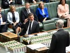 Australian Opposition leader Angus Taylor reacts as he listens to Australian Home Affairs Minister Tony Burke during Question Time on Monday. 
