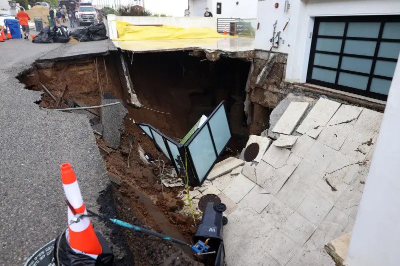 Part of the road and the home's driveway were swallowed by the hole.