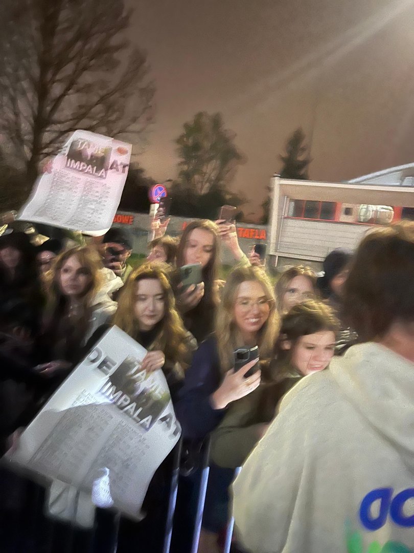 Tame Impala fans wait for an autograph.