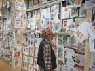 A man looks at a wall covered with photographs of people reported missing after the deadly floods in the Himalayan valley.