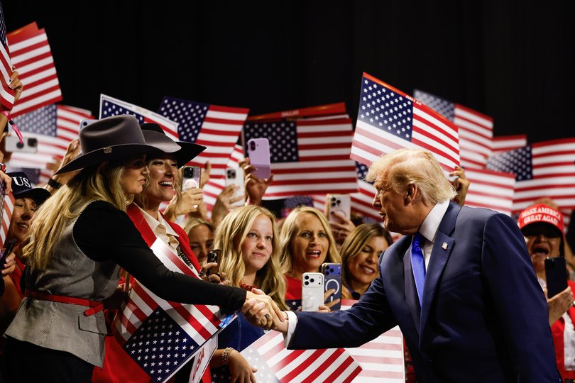 U.S. President Donald Trump greets attendees as he walks on stage to speak on the first day of the 2026 Republican National Convention in Dallas, Texas.