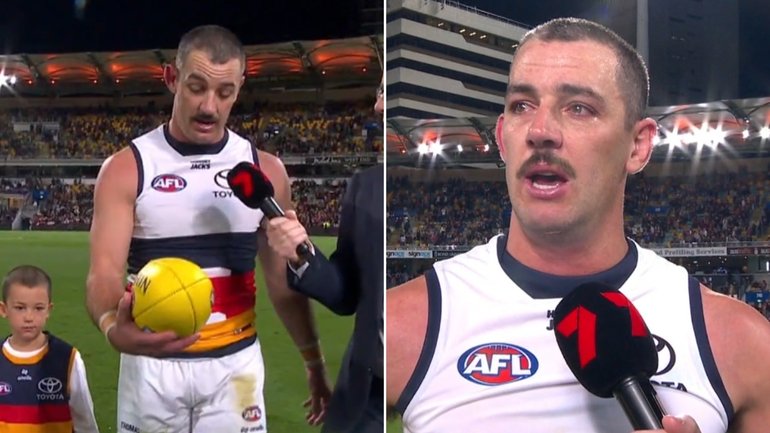Taylor Walker leaves with the match ball after his final AFL game.
