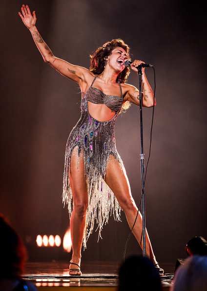 Miley Cyrus wears a Bob Mackie design as she performs onstage during the 66th GRAMMY Awards.