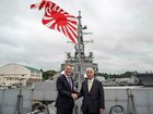 Australia's Defence Minister Richard Marles and Japan's Defence Minister Gen Nakatani shake hands.