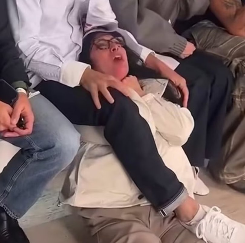 Mr Kolb was filmed pinning one of the activists to the floor using his arms and legs to keep the woman restrained.