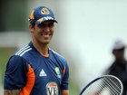 Australian cricketer Mitchell Johnson poses with a tennis racket during a practice session at the Pallekele International Cricket Stadium in Pallekele on September 6, 2011. Michael Clarke will look to put his first Test series as Australia's captain beyond Sri Lanka's reach when the second match opens in Pallekele on September 8, 2011. The tourists won the first Test on a controversial dusty wicket in Galle by 125 runs last week to take the lead in the three-match series, Australia's first in Sri Lanka since 2004. AFP PHOTO/Ishara S. KODIKARA (Photo by Ishara S.KODIKARA / AFP) ISHARA S.KODIKARA