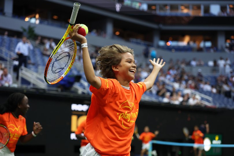 Kids run onto the court at the US Open.