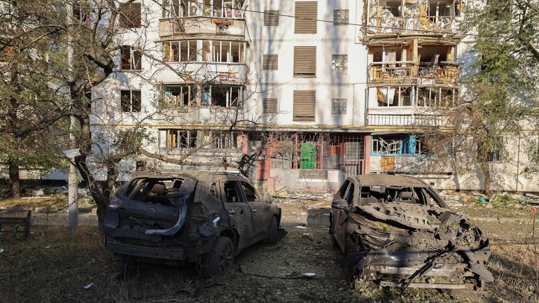 Burnt-out vehicles in front of a damaged residential building in Kyiv on Thursday. 