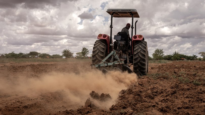 A farmer plants onions on a co-operative farm in Somalia. Spiralling energy and fertiliser costs threaten to drive up food prices.