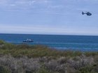 Emergency services have dispatched helicopters and water police to the beach. 
